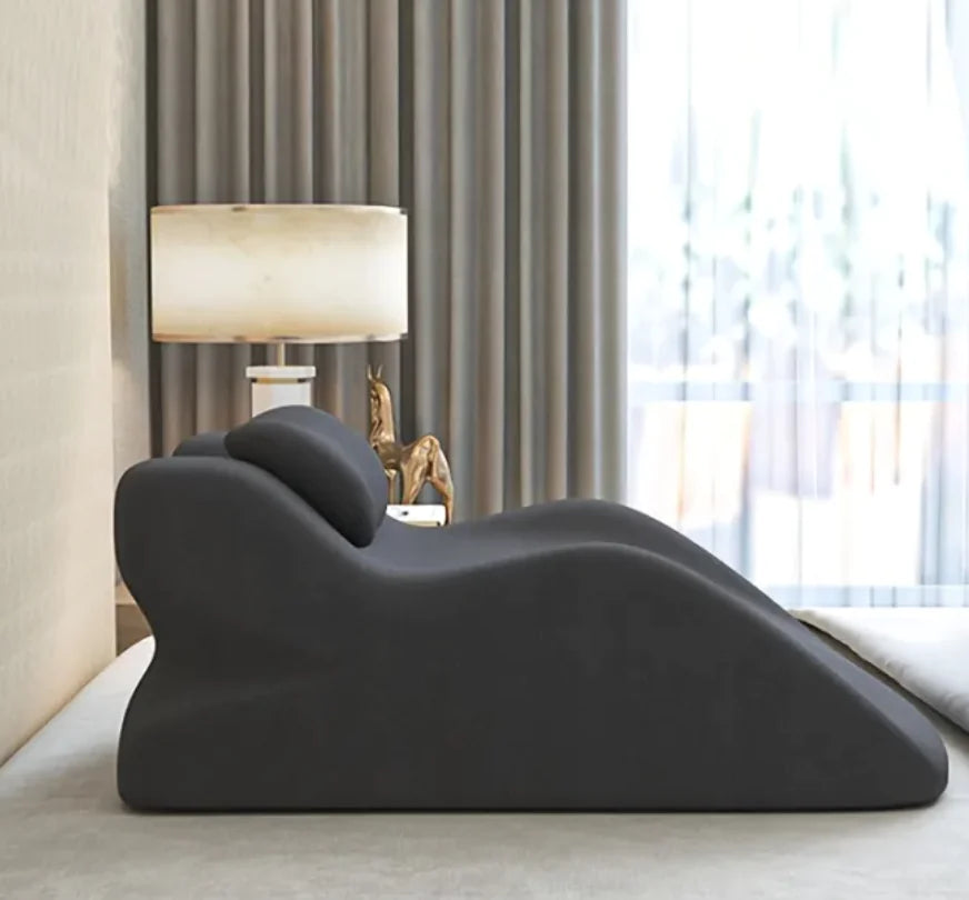 Modern gray sofa in a stylish living room with a lamp and curtains.